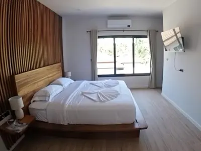 a bedroom with a large bed and a large window at Rawai 2 Bedrooms Private Pool Villa in Ban Saiyuan (1)