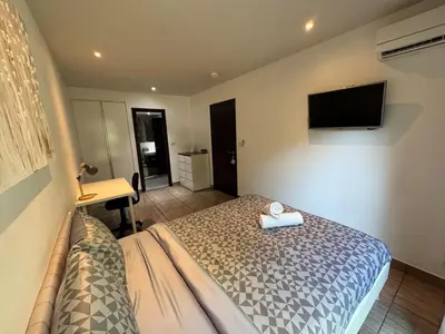 a bedroom with a bed and a tv on the wall at Apartment Title II, Rawai Phuket in Rawai Beach