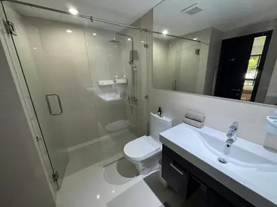 a bathroom with a shower and a toilet and a sink at Apartment Title II, Rawai Phuket in Rawai Beach