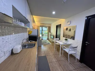 a kitchen with a sink and a table with chairs at Apartment Title II, Rawai Phuket in Rawai Beach