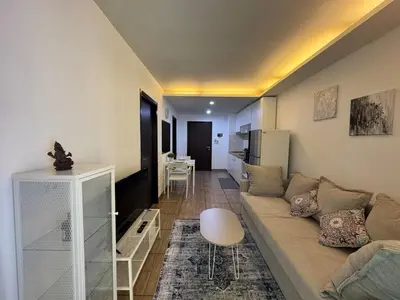 a living room with a couch and a table at Apartment Title II, Rawai Phuket in Rawai Beach