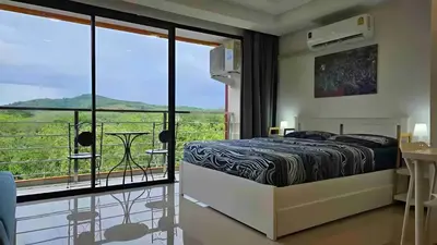 a bedroom with a bed and a balcony at CC620 View of Green Hills in Ban Mai Salae