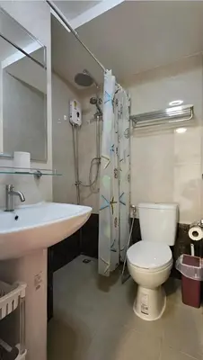 a bathroom with a sink and a toilet and a mirror at CC620 View of Green Hills in Ban Mai Salae