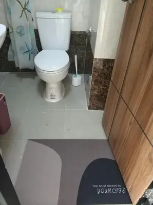 a bathroom with a toilet and a toilet brush at CC620 View of Green Hills in Ban Mai Salae