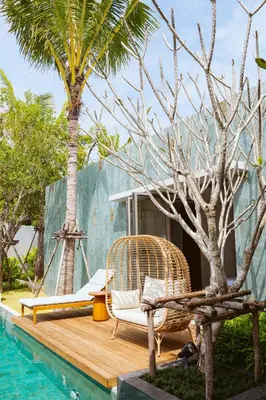 a resort with a pool and chairs and a palm tree at Anchan Flora Luxury 2BR Pool Villa in Thalang