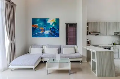a living room with a couch and a table at V144 Luxury Private Pool Villa in Ban Saiyuan (1)
