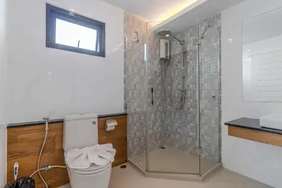 a bathroom with a shower with a toilet and a sink at V144 Luxury Private Pool Villa in Ban Saiyuan (1)
