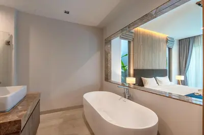 a bathroom with a tub and a sink and a mirror at V217 Brand New 3BR Villa Near Beach & Boat Avenue in Thalang
