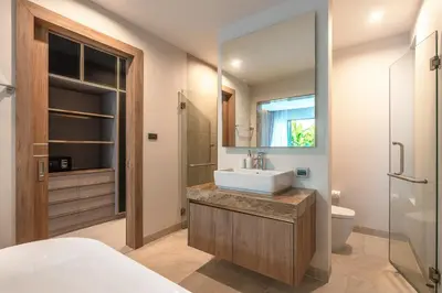 a bathroom with a sink and a toilet and a mirror at V217 Brand New 3BR Villa Near Beach & Boat Avenue in Thalang