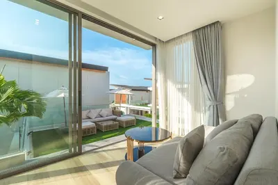 a living room with a couch and a large window at V217 Brand New 3BR Villa Near Beach & Boat Avenue in Thalang