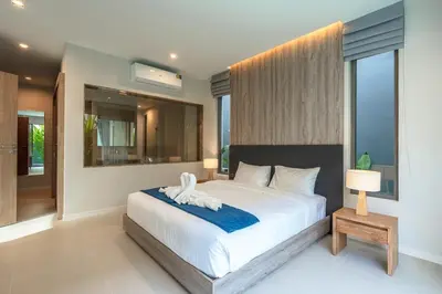 a bedroom with a large bed with a large window at V217 Brand New 3BR Villa Near Beach & Boat Avenue in Thalang