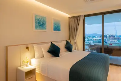 a hotel room with a bed and a large window at Lakefront suite The Aqua at Boat avenue in Bang Tao Beach