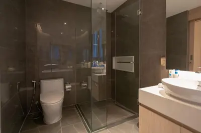 a bathroom with a shower and a toilet and a sink at Lakefront suite The Aqua at Boat avenue in Bang Tao Beach