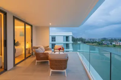 a balcony with a view of the water at Lakefront suite The Aqua at Boat avenue in Bang Tao Beach