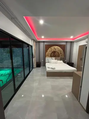 a bedroom with a bed and a swimming pool at Luxury 4BR Private Pool Villa Sunset Rooftop in Phuket Town