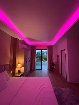 a bedroom with pink lights on the ceiling at Luxury 4BR Private Pool Villa Sunset Rooftop in Phuket Town
