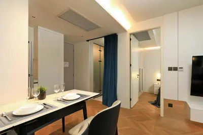 a dining room with a table and chairs and a television at 2BR Layan Beach Apartment Capital Pro Kora D244 in Layan Beach