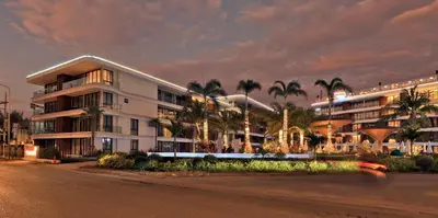 a building with palm trees in front of a street at 2BR Layan Beach Apartment Capital Pro Kora D244 in Layan Beach