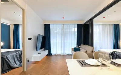 a hotel room with a dining table and a bedroom at 2BR Layan Beach Apartment Capital Pro Kora D244 in Layan Beach