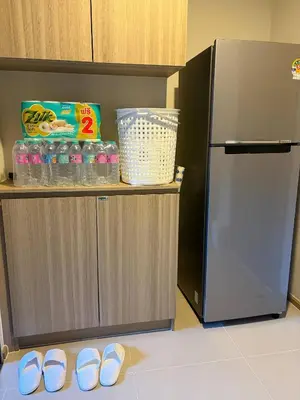 a pair of shoes sitting on the floor next to a refrigerator at Phuket, Best location, full furnished 1bedroom in Ban Rangeng