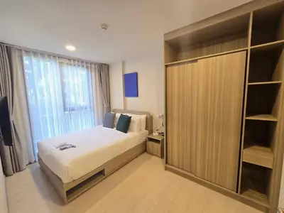a bedroom with a bed and a large window at Phuket, Best location, full furnished 1bedroom in Ban Rangeng