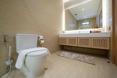 a bathroom with a white toilet and a sink at Duplex 5 & 4 BR Private Pool Villa - Laguna Phuket in Laguna Phuket