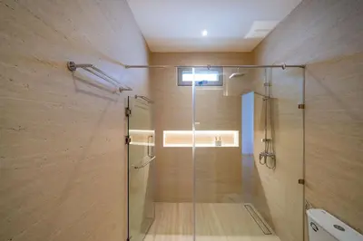 a shower with a glass door in a bathroom at Duplex 5 & 4 BR Private Pool Villa - Laguna Phuket in Laguna Phuket