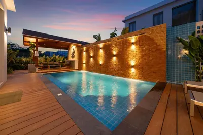 a swimming pool in the backyard of a house at Duplex 5 & 4 BR Private Pool Villa - Laguna Phuket in Laguna Phuket