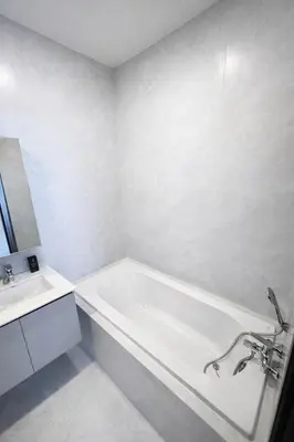 a white bathroom with a tub and a sink at 2BR Apartment, 10-Min Walk to the Beach in Laguna Phuket
