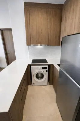 a kitchen with a washing machine in the middle of a counter at 2BR Apartment, 10-Min Walk to the Beach in Laguna Phuket