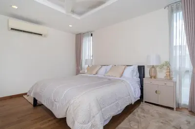 a white bedroom with a bed and a window at Lux Laguna Park 5 bedroom rooftop pool in Laguna Phuket