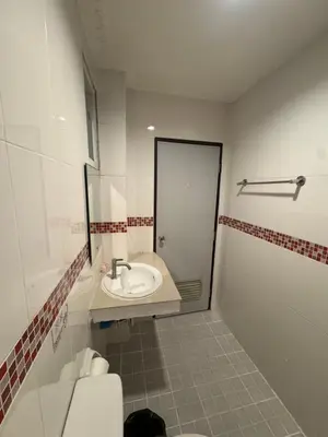 a bathroom with a sink and a toilet and a shower at Luxus Guesthouse in Patong Beach