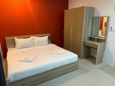 a bedroom with a bed with two towels on it at Luxus Guesthouse in Patong Beach