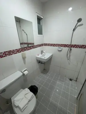 a bathroom with a toilet and a sink and a shower at Luxus Guesthouse in Patong Beach