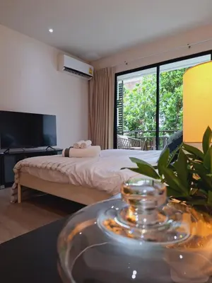 a hotel room with a bed and a large window at The title Aparthotel by Perfect Rawai Holiday Homes in Rawai Beach