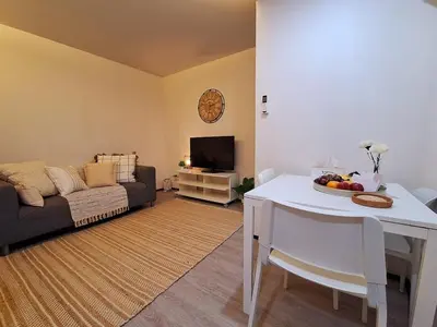 a living room with a white table and a couch at The title Aparthotel by Perfect Rawai Holiday Homes in Rawai Beach