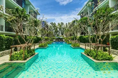 a swimming pool in the middle of a building at The title Aparthotel by Perfect Rawai Holiday Homes in Rawai Beach