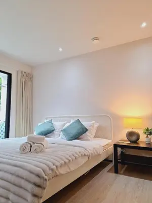 a bedroom with a bed with towels on it at The title Aparthotel by Perfect Rawai Holiday Homes in Rawai Beach