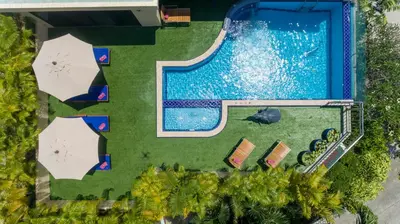 an overhead view of a swimming pool with umbrellas at Sea View Luxury Villas Kata Beach in Kata Beach