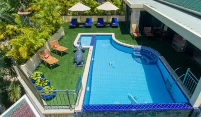 an overhead view of a swimming pool with chairs and umbrellas at Sea View Luxury Villas Kata Beach in Kata Beach