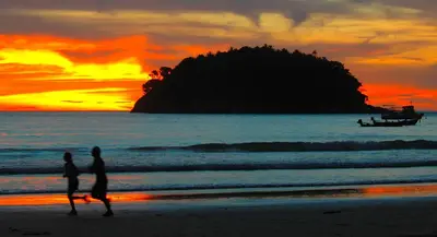 a couple walking on the beach at sunset at Sea View Luxury Villas Kata Beach in Kata Beach