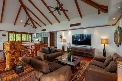 a living room with couches and a tv at Stunning Sea & Sunset Views Villa over Patong Bay in Patong Beach