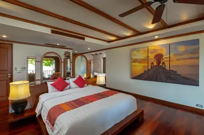 a bedroom with a large bed with red pillows at Stunning Sea & Sunset Views Villa over Patong Bay in Patong Beach