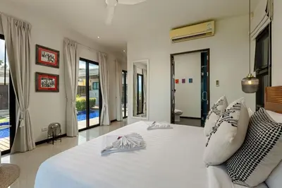 a bedroom with a large bed with white sheets and pillows at Ocean-View 3-Bed Villa Retreat - Ao Yon Hillside in Ban Ao Makham