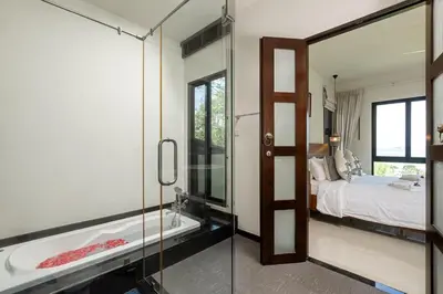 a bathroom with a bath tub and a bedroom at Ocean-View 3-Bed Villa Retreat - Ao Yon Hillside in Ban Ao Makham