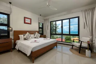 a bedroom with a large bed and large windows at Ocean-View 3-Bed Villa Retreat - Ao Yon Hillside in Ban Ao Makham