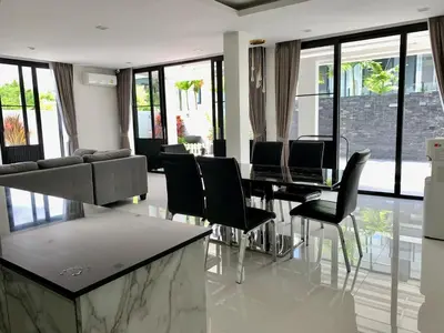 a living room with a dining table and chairs at 6-Bedroom Villa in Laguna Park 2 Phuket in Ban Phru Champa