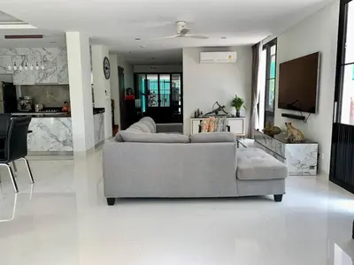 a living room with two couches and a kitchen at 6-Bedroom Villa in Laguna Park 2 Phuket in Ban Phru Champa