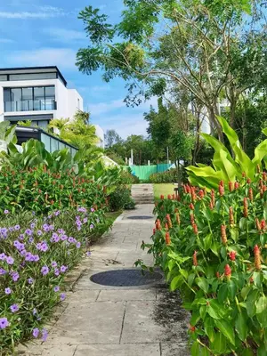 a garden of flowers with a building in the background at 6-Bedroom Villa in Laguna Park 2 Phuket in Ban Phru Champa