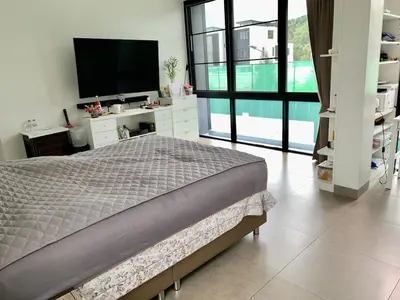 a bedroom with a bed and a flat screen tv at 6-Bedroom Villa in Laguna Park 2 Phuket in Ban Phru Champa